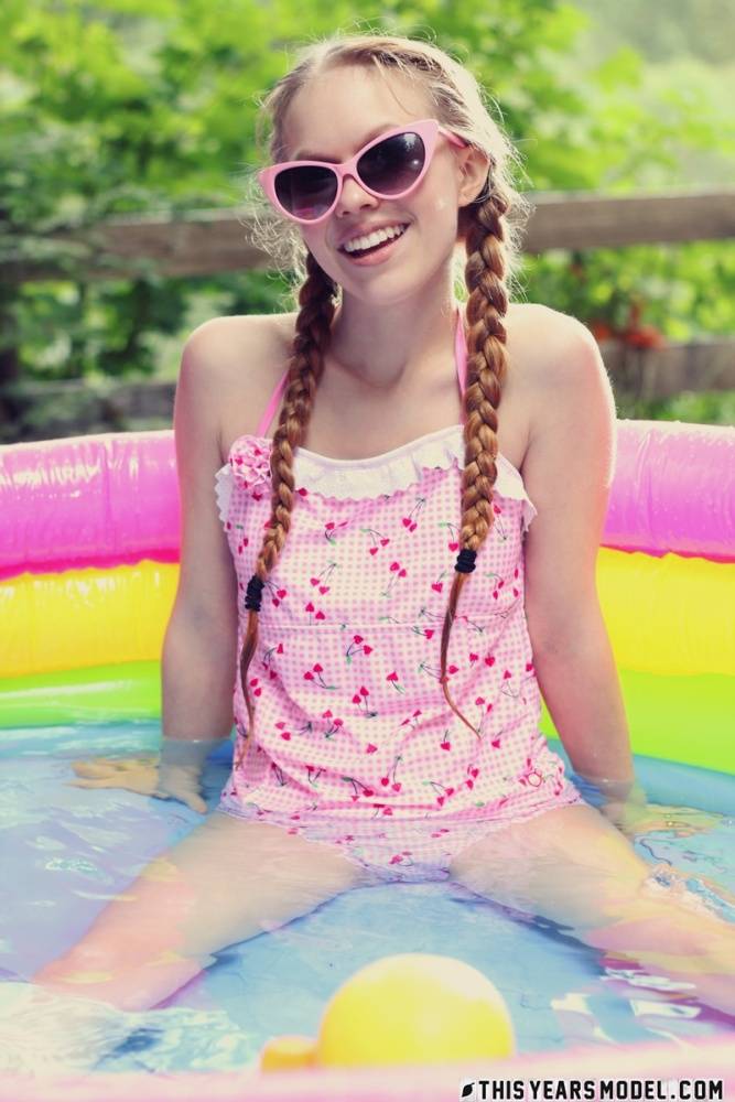 Adorable teen Dolly Little tugs on her braided pigtails in a blowup pool - #4