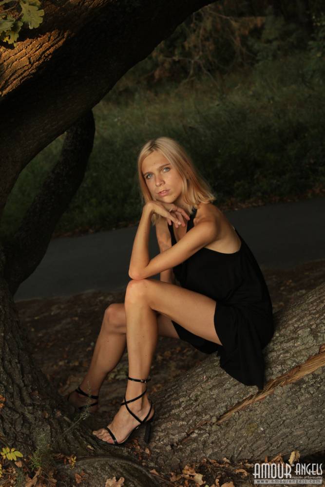 Skinny blonde teen Nora doffs a little black dress to get naked outdoors - #16