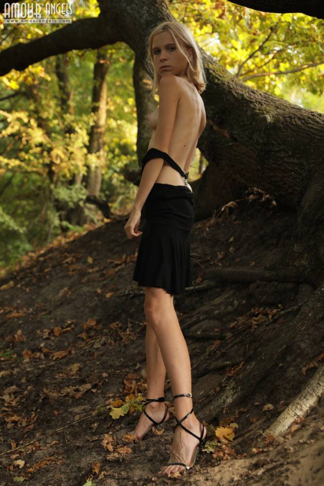Skinny blonde teen Nora doffs a little black dress to get naked outdoors - #9