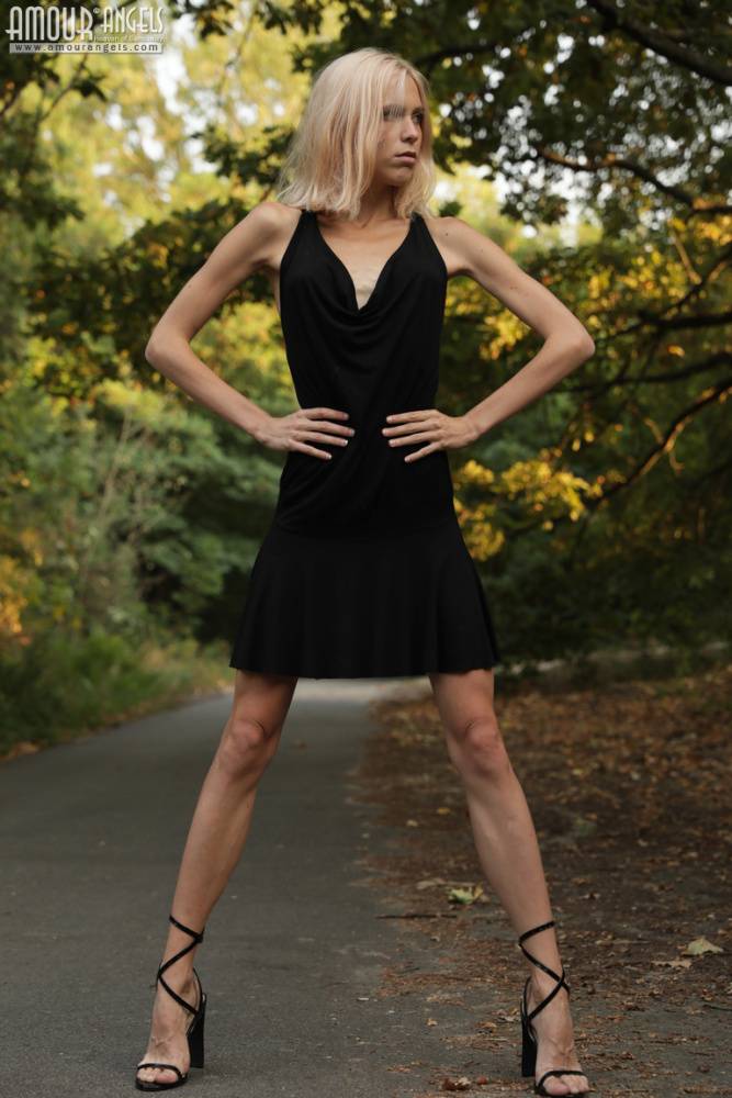 Skinny blonde teen Nora doffs a little black dress to get naked outdoors - #15