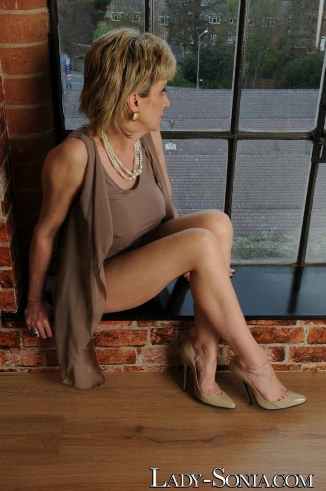 Older UK blonde Lady Sonia shows her bare legs while wearing a dress and heels - #1