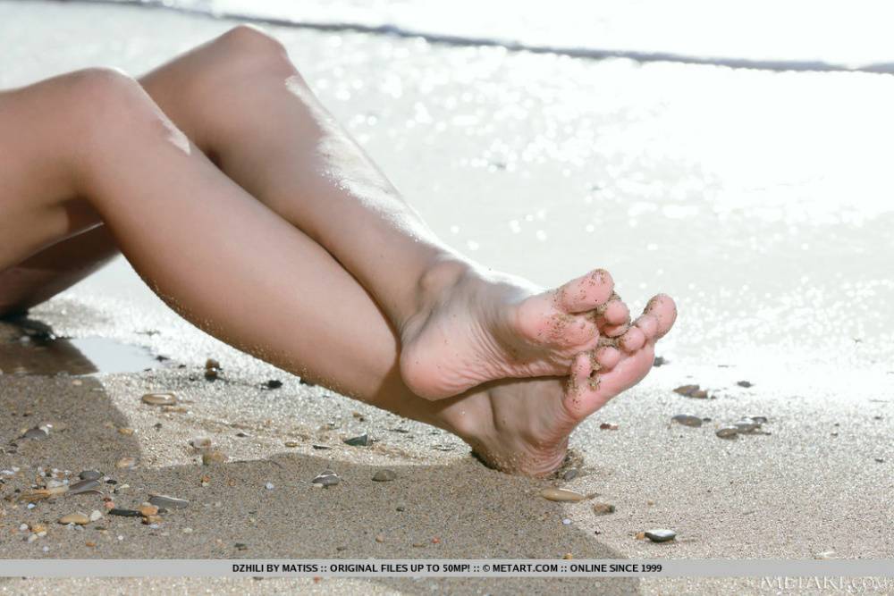 Beautiful Dzhili is out and about on a secluded beach when she starts to strip | Photo: 1661332