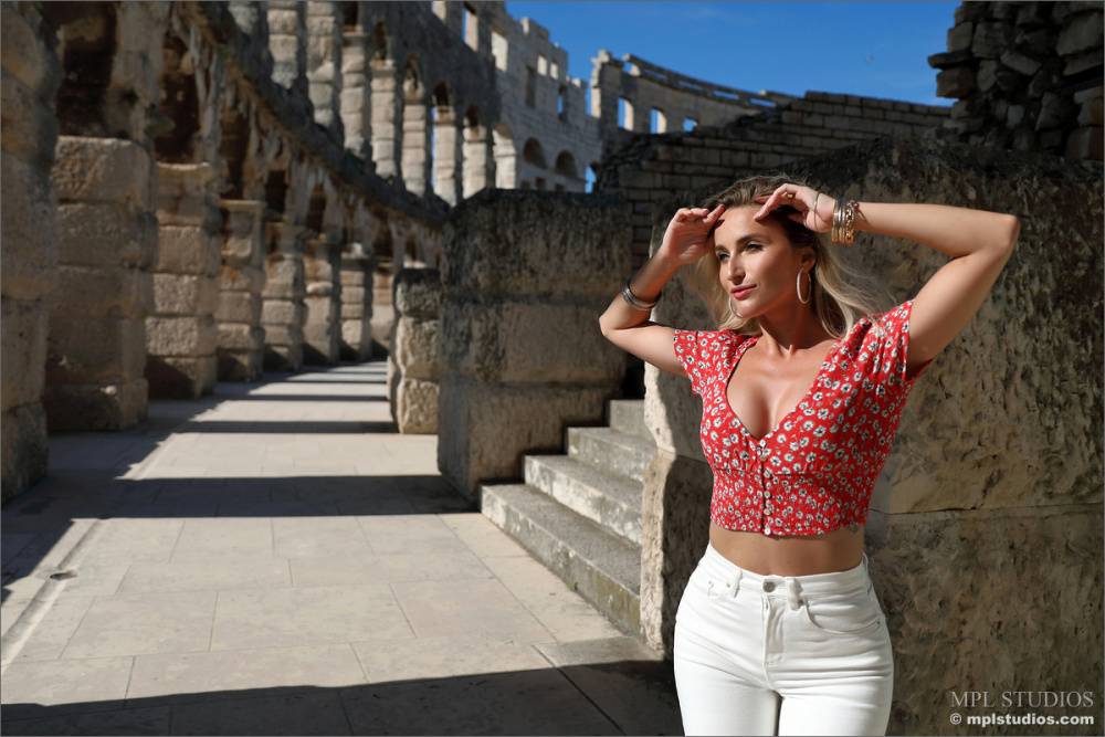Dirty blonde poses at the Colosseum for a safe for work modelling gig - #8