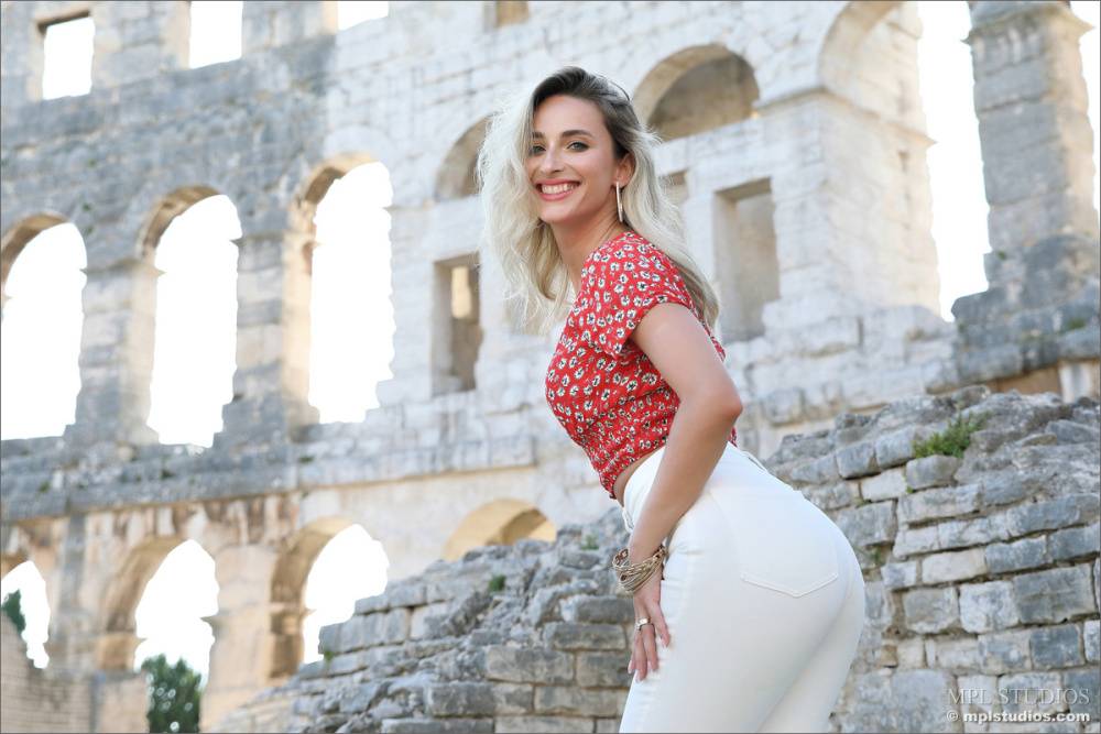 Dirty blonde poses at the Colosseum for a safe for work modelling gig - #11