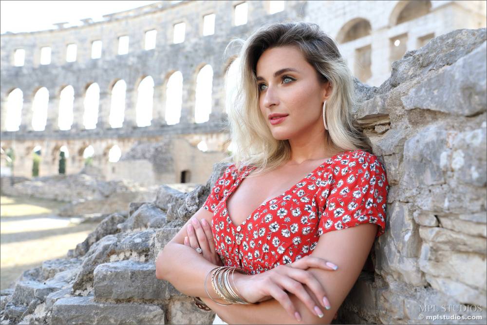 Dirty blonde poses at the Colosseum for a safe for work modelling gig - #1