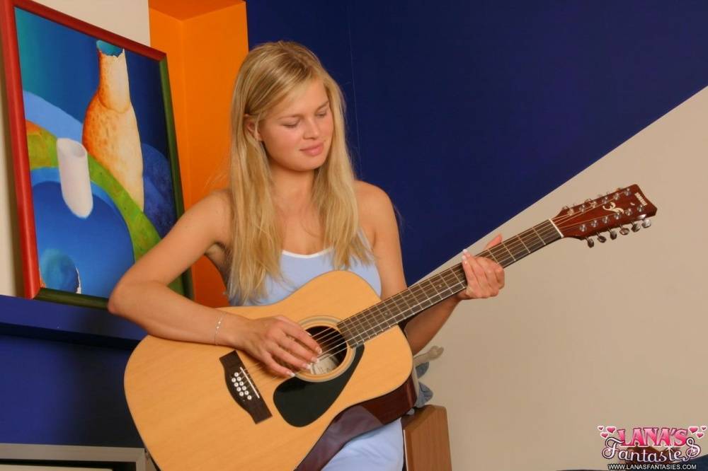 Blonde teen strums a 12 string guitar while getting totally naked - #13
