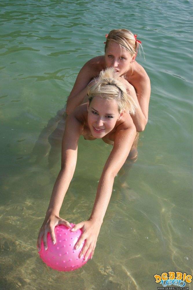 Blonde girls hump each other while going topless on a private beach - #4