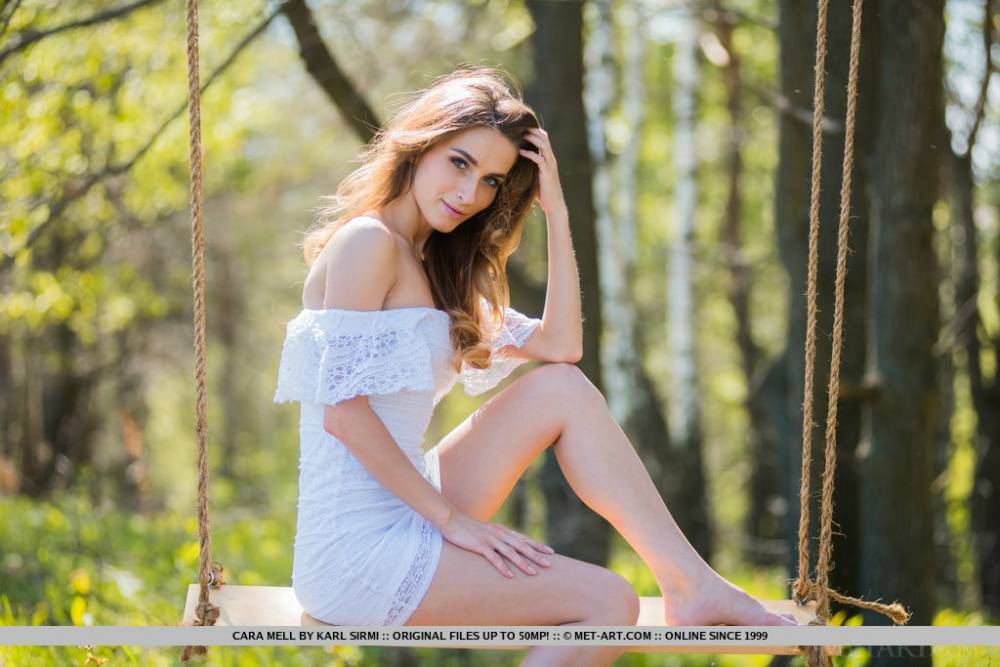 Young brunette Cara Mell unveils her great body on a swing in the woods | Photo: 85796