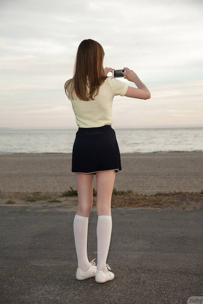 Skinny brunette teen Audrey Star posing in a skimpy skirt outdoors | Photo: 86881