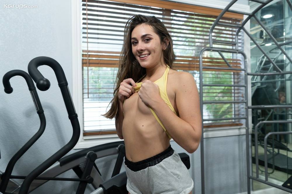 Teen amateur Mackenzie Mace slides her shorts to one side in a home gym - #9
