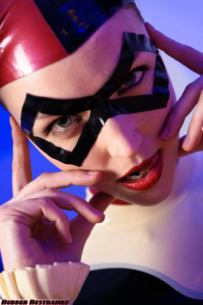 Solo model Harley Quinn poses for a non nude shoot in a costume made of latex - #4