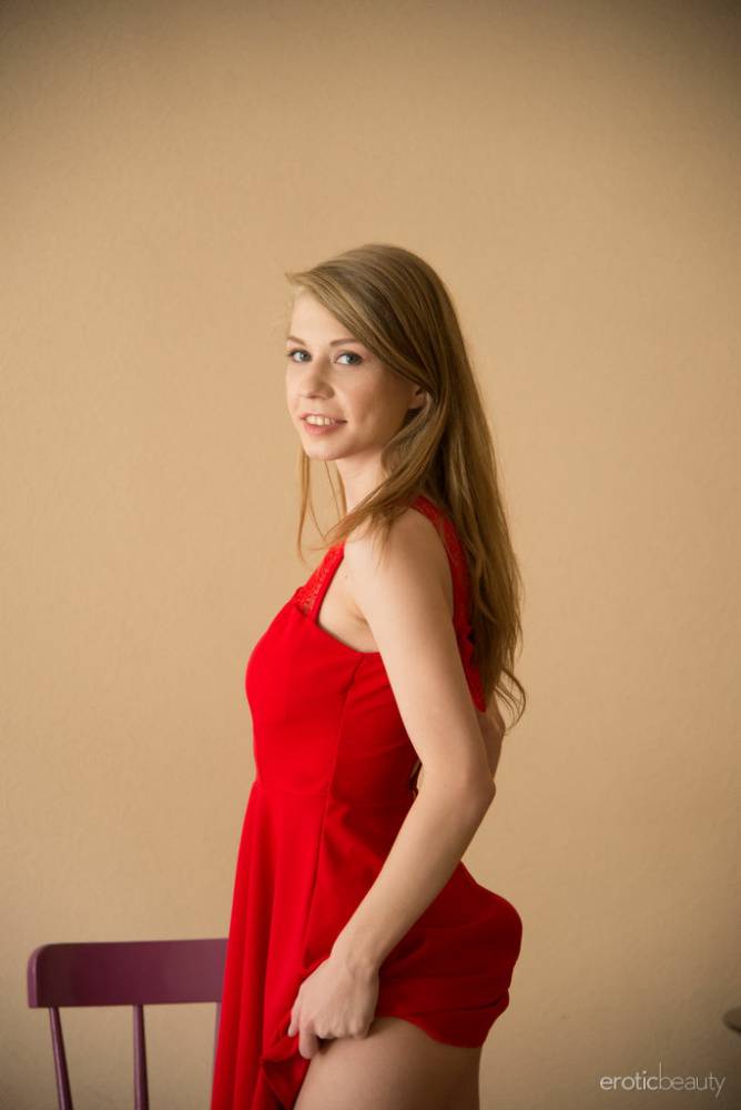 Nice young girl Eva Gold chucks aside a red dress to pose in the nude - #4