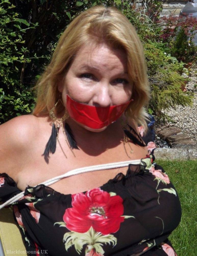 Busty blonde is restrained and gagged in a garage and in a backyard as well | Photo: 107084