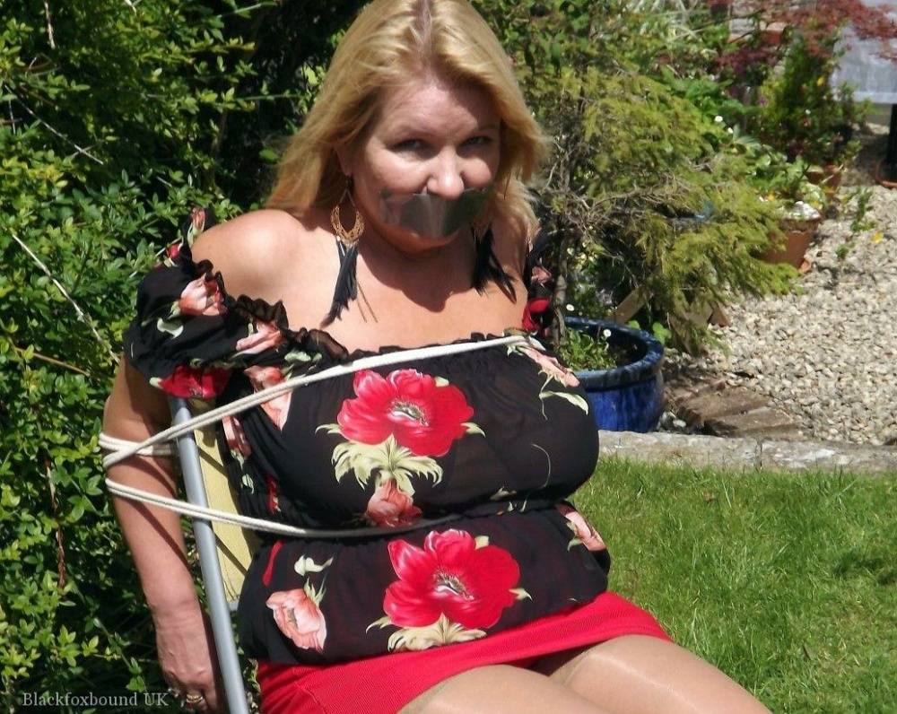 Busty blonde is restrained and gagged in a garage and in a backyard as well | Photo: 107080