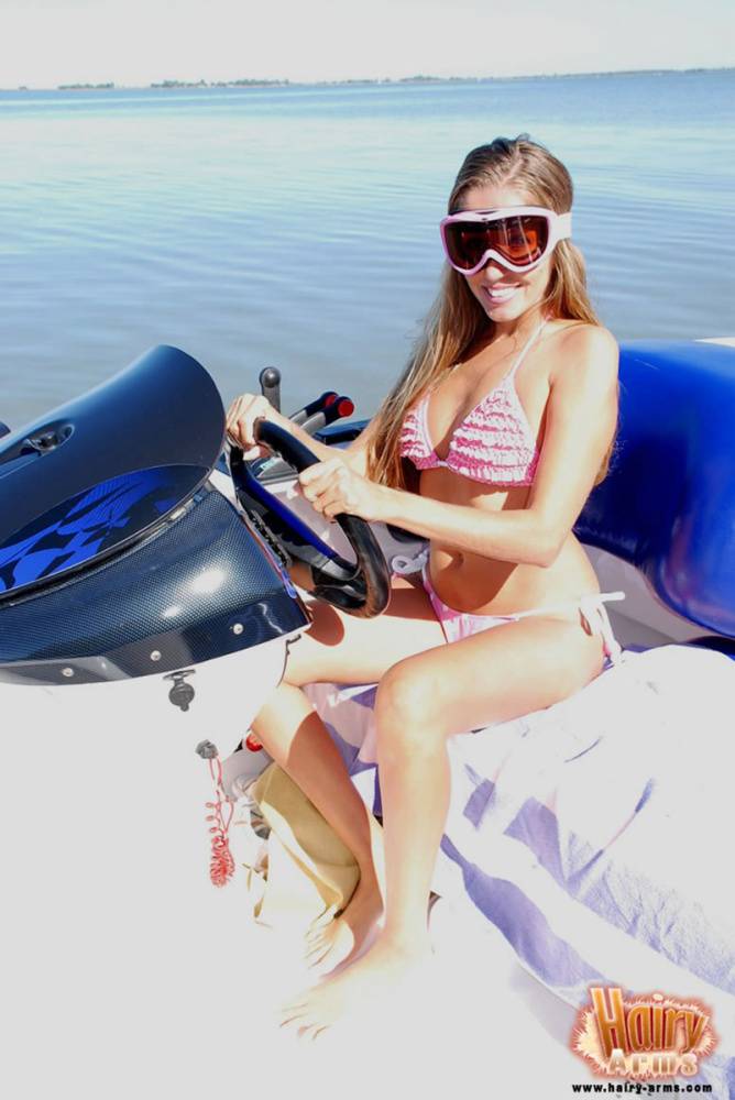 Lori Anderson licks her lips on a watercraft in a bikini and goggles - #9
