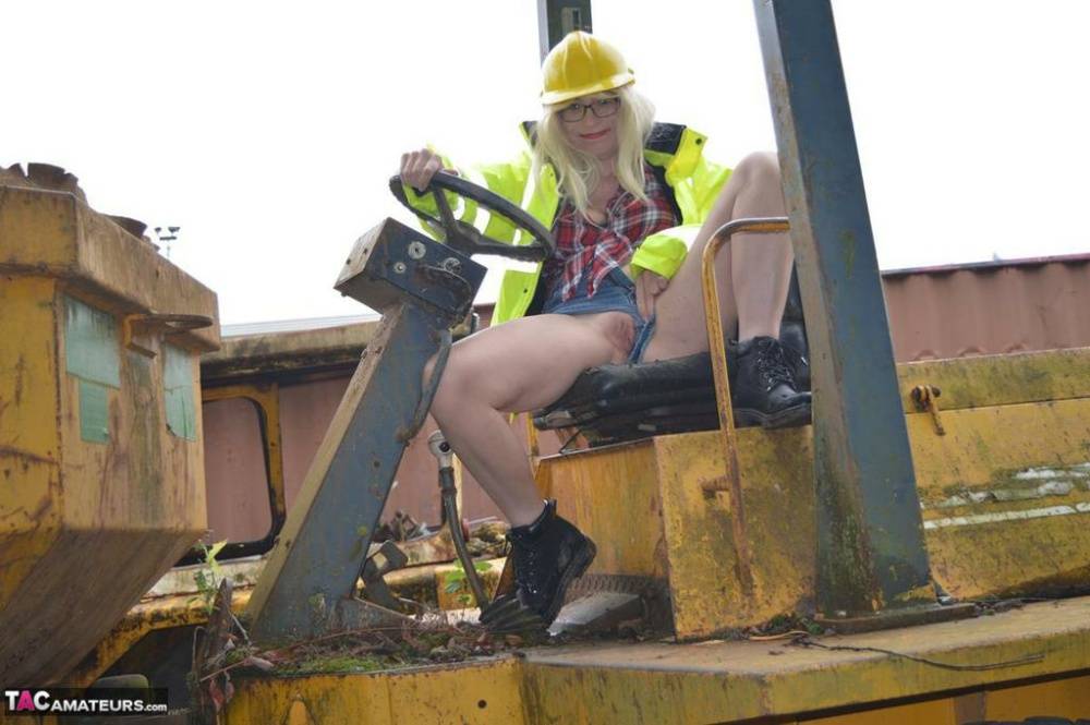 Mature amateur Barby Slut exposes herself on heavy equipment at a job site - #5