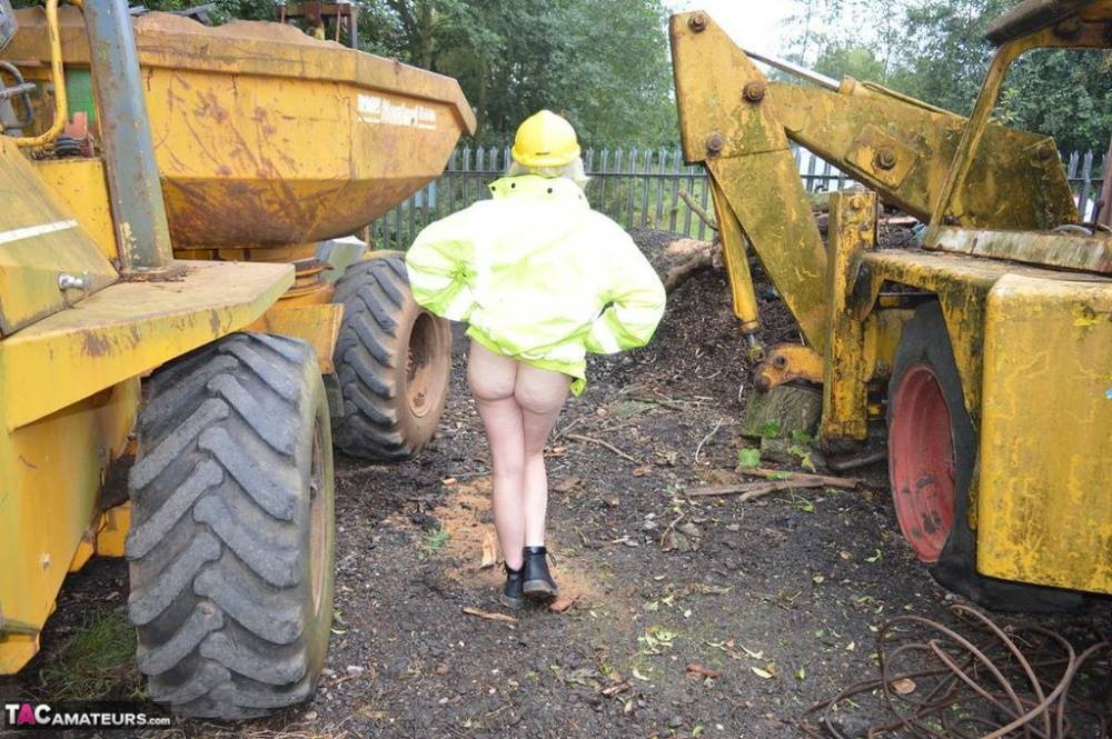 Mature amateur Barby Slut exposes herself on heavy equipment at a job site - #16