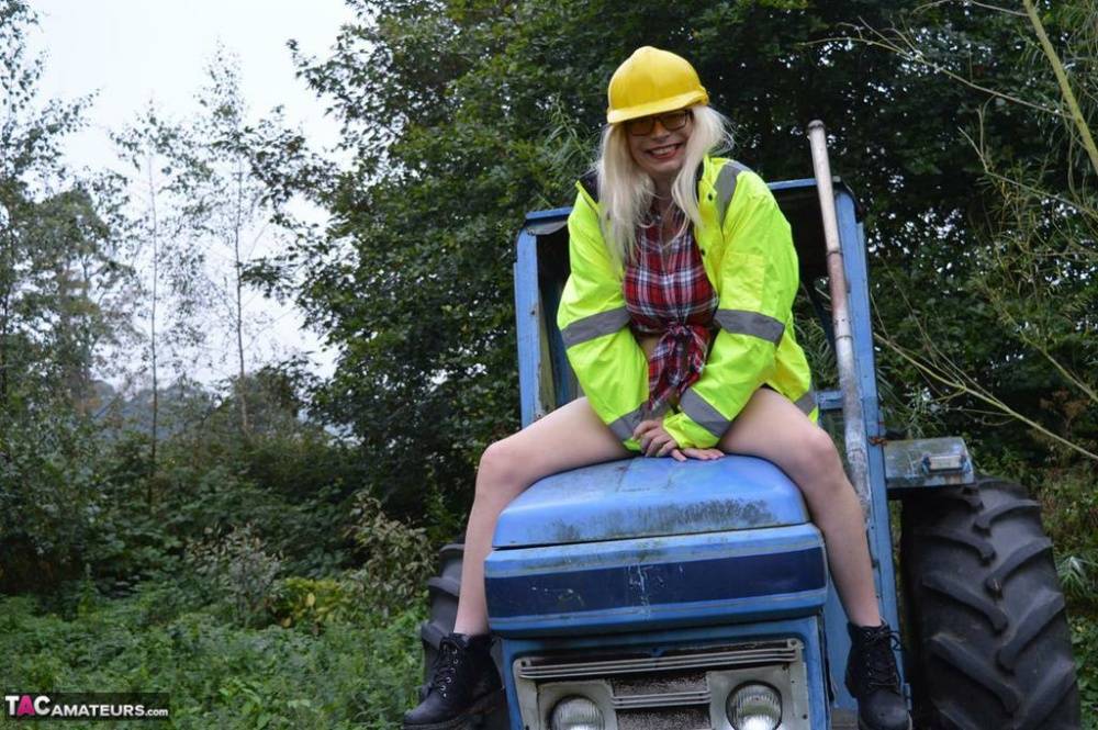 Mature amateur Barby Slut exposes herself on heavy equipment at a job site - #10