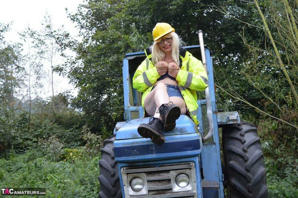 Mature amateur Barby Slut exposes herself on heavy equipment at a job site - #11