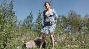 Clothed woman Sasha S hitches up her dress to take a pee on a rock - #main