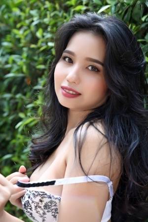 Beautiful Asian girl Norah gets totally naked next to a hedge in a garden - #main