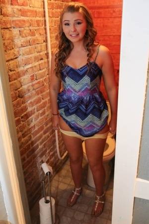 Cute teen gets totally naked after being caught on the toilet on galphoto.com