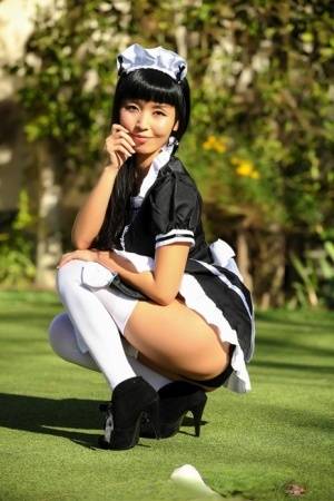 Japanese maid Marica Hase exposes her tits and twat on a putting green - Japan on galphoto.com