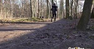 Naomi Benet squats in the woodland to piss on galphoto.com