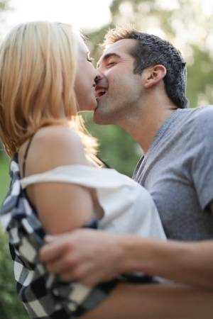 Blonde girl Cece Capella and Donnie Rock kiss with their clothes on outdoors on galphoto.com