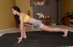 Cute brunette babe Aruna Aghora doing yoga in shorts and bare feet on www.galphoto.com
