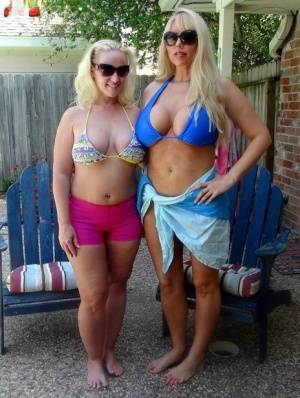 Blonde chicks Karen Fisher and Dee Siren loose their big tits from bikini tops on galphoto.com