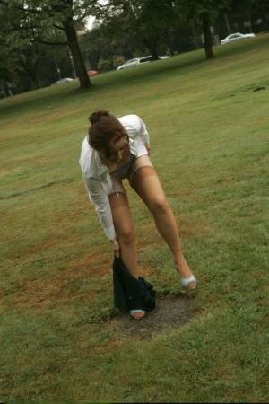 Amateur chick Dirty Angie strips to her pretties and tan nylons in a park on galphoto.com