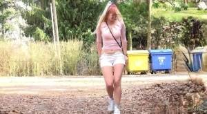 Blonde girl Katy Sky pulls down her shorts to piss in the ditch of a dirt road on www.galphoto.com