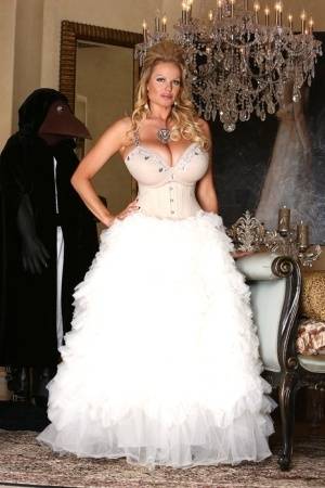 Blonde chick Kelly Madison releases her big tits from her white gown on galphoto.com