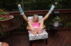 Thin blonde Sky Pierce attaches clamps to her wide open pussy on a deck on galphoto.com