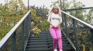 Blonde Victoria Pure pulling down her tight pants to pee on the bleachers on galphoto.com