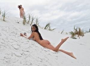 Hot lesbians Cassie Laine & Breanne Benson frolic naked on a sand dune on galphoto.com