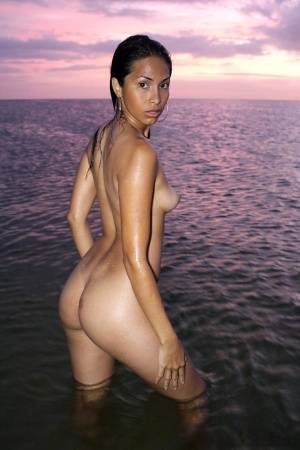 Latina model Ruth Medina poses nude for a solo shoot at the beach on galphoto.com