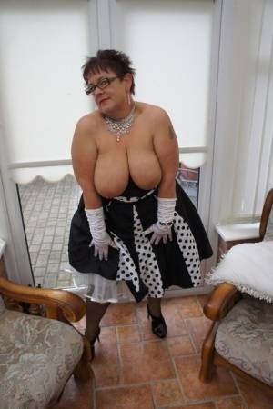 Mature plumper Warm Sweet Honey proudly displays her huge breasts on galphoto.com