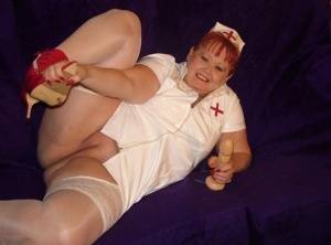 Mature redheaded nurse Valgasmic Exposed exposes herself during dildo play on www.galphoto.com