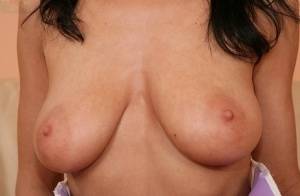 European babe freeing big MILF tits from uniform before masturbating on galphoto.com