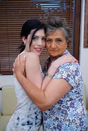 Lesbian granny worshipping sexy teen's attractive body and holes on galphoto.com