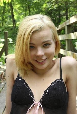 Cute teen amateur Sophia Kitten posing in nude in knee high socks in woods on galphoto.com