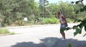 Blonde female Nikki Dream can't hold her pee any longer and squats on roadway on galphoto.com