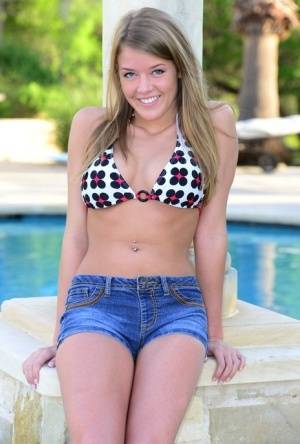 Cute teen Sophia Wood drops her shorts by the pool to toy with a vibrator on www.galphoto.com