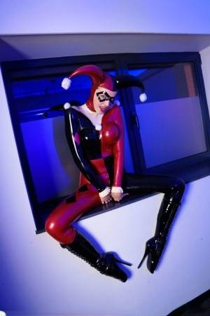 Solo model Dutch Dame poses in a Harley Quinn themed latex outfit