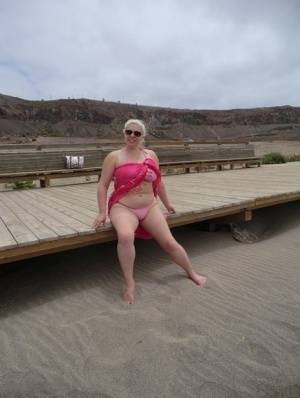 Older platinum blonde Barby exposes her plump body at the seaside on galphoto.com