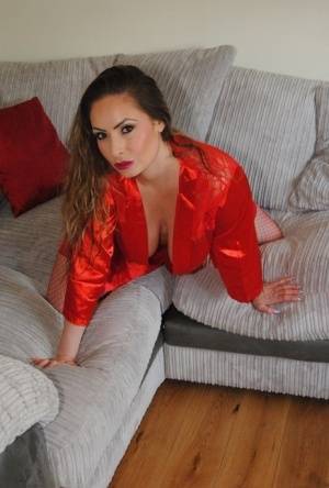 Busty amateur Sophia Delane rubs her cunt on a sofa in a robe and mesh hosiery on galphoto.com