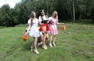 Horny femdom girls in costume head to the field to milk their naked man slave